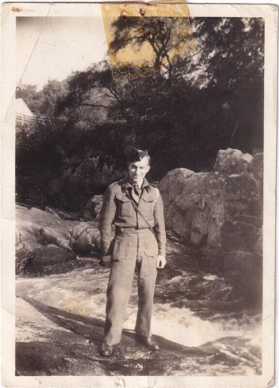 W.I. (Bill) Hann in uniform beside the water, front