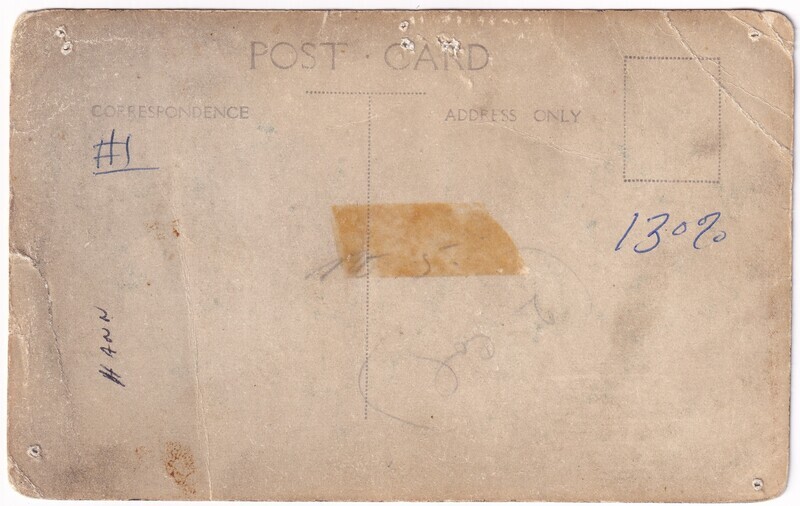 The image is of the worn and aged back of a photograph. In the top center, the text "POST CARD" is printed, with a vertical dotted line dividing the sections for "CORRESPONDENCE" on the left and "ADDRESS ONLY" on the right. There is a rectangular outline for a stamp in the top right corner. Handwritten in blue ink are the numbers "#1" in the correspondence section and "130%” on the right side, near the address section. On the left, handwritten in black ink is "Hann", and an old piece of brown tape marks the center. The card shows signs of wear, including darkened edges and small stains.