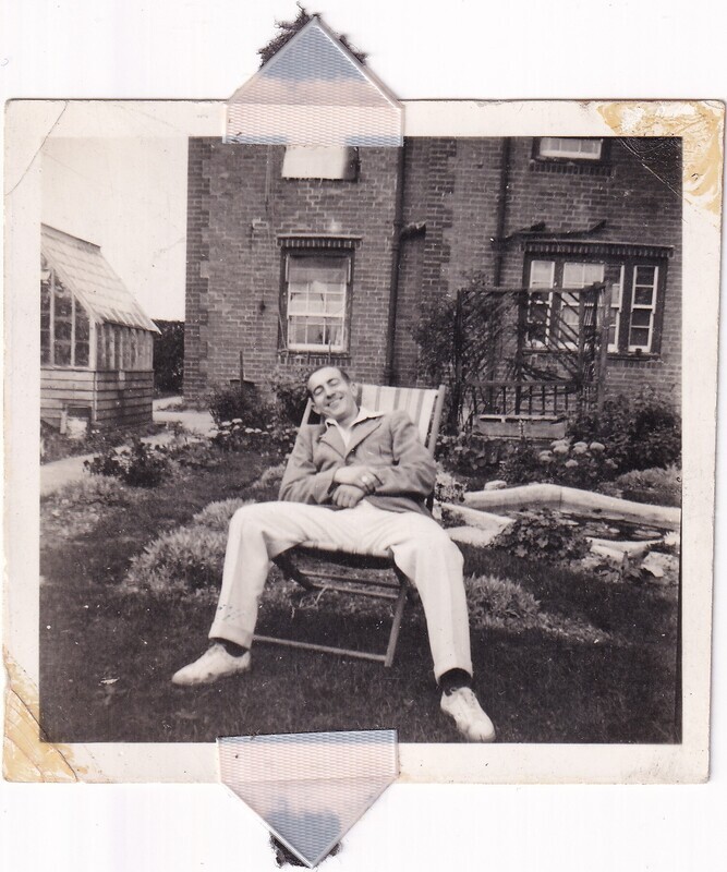 W.I. (Bill) Hann sitting in Mrs. Packer's garden, front