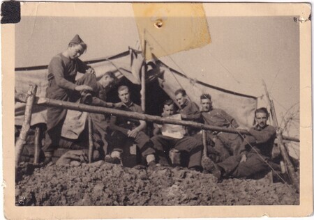 A photo of a Newfoundland gun crew [including Murdoch Sweet reading the paper taken in Algeria or Tunisia]
