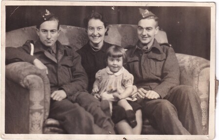 A photo of W.I. (Bill) and Harold Hann, their sister Elsie, and her daughter Kathleen sitting on a sofa