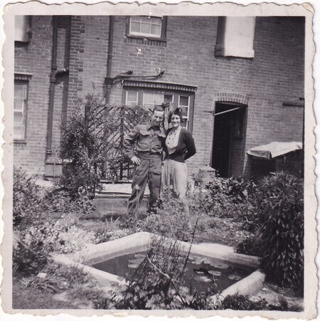 A photo of W.I. (Bill) Hann and Adelaide Lilian (née Ditchburn) Packer standing in the garden of her house [40 Ridham Avenue] in Kemsley, Kent, England