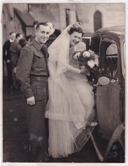 A photo of W.I. (Bill) and Mary (née Mann) Hann entering a car taken at their wedding at the New Kilpatrick Parish Church in Glasgow, Scotland