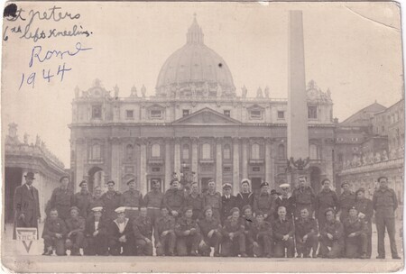 A photo of a large group of soldiers with St. Peter's Basilica in the background including Murdoch Sweet kneeling sixth from the left